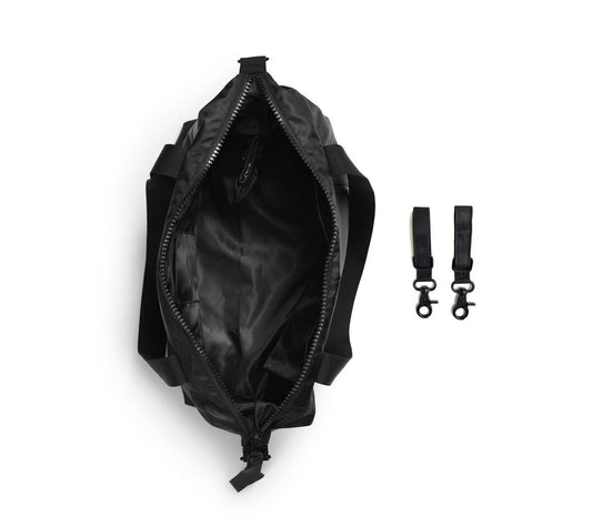 Glansende zwart -veranderende tas